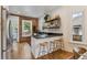 Charming kitchen featuring a breakfast bar, brickwork, and ample natural light with stainless steel appliances at 2765 W Denver Pl, Denver, CO 80211