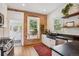 Kitchen features red brick wall, stone countertop, white cabinets, stainless steel appliances, and view to the backyard at 2765 W Denver Pl, Denver, CO 80211