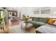 Spacious living room with open layout, a comfortable sofa, and stylish decor with hardwood flooring at 2765 W Denver Pl, Denver, CO 80211