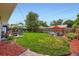 A sprawling backyard featuring a lush lawn, patio set, and a shade sail, perfect for outdoor entertaining at 3775 S Green Ct, Englewood, CO 80110
