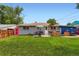 A backyard featuring a lush lawn, patio set, BBQ, and an umbrella, perfect for outdoor entertaining at 3775 S Green Ct, Englewood, CO 80110