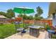 Outdoor patio with seating, fire pit, and shade umbrella at 3775 S Green Ct, Englewood, CO 80110