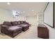 Spacious basement with plush purple sectional couch and home theater setup at 3775 S Green Ct, Englewood, CO 80110