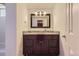 Bathroom featuring a dark vanity with marble countertop and framed mirror at 3775 S Green Ct, Englewood, CO 80110