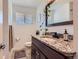 Bathroom features granite countertops, white tile, and modern vanity at 3775 S Green Ct, Englewood, CO 80110