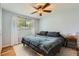 Bedroom with soft blue walls, ceiling fan, natural light, and calming decor at 3775 S Green Ct, Englewood, CO 80110
