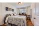 Cozy bedroom with hardwood floors, plants, natural light, and neutral decor at 3775 S Green Ct, Englewood, CO 80110
