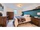 Cozy bedroom featuring plush carpet, dresser, and floating shelves at 3775 S Green Ct, Englewood, CO 80110