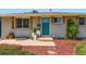 Close-up of a charming home's entrance with a blue door, decorative shutters, and well-kept landscaping at 3775 S Green Ct, Englewood, CO 80110