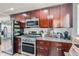 Kitchen with stainless steel appliances, modern cabinets, and granite countertops at 3775 S Green Ct, Englewood, CO 80110