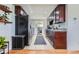 Modern kitchen with stainless steel appliances, dark wood cabinets, and white tile backsplash at 3775 S Green Ct, Englewood, CO 80110