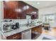 Updated kitchen featuring dark cabinets, stainless steel appliances, and granite countertops at 3775 S Green Ct, Englewood, CO 80110
