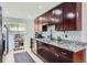 Contemporary kitchen with dark cabinetry, stainless steel appliances, and granite countertops at 3775 S Green Ct, Englewood, CO 80110