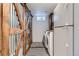 Laundry area features washer/dryer, barn doors, and tile flooring at 3775 S Green Ct, Englewood, CO 80110