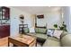 Living room with an olive sofa, light colored pillows, and hardwood floors at 3775 S Green Ct, Englewood, CO 80110