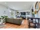 Open-concept living area with hardwood floors, comfortable seating, and seamless kitchen access at 3775 S Green Ct, Englewood, CO 80110