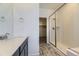 Modern bathroom featuring a glass-enclosed shower, a single vanity, and neutral tile flooring at 1978 S Haleyville Way, Aurora, CO 80018