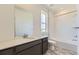 Modern bathroom featuring a vanity, toilet, and a bathtub with white tile surround and chrome fixtures at 1978 S Haleyville Way, Aurora, CO 80018