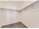 A clean, empty walk-in closet featuring neutral walls, carpet, and adjustable shelving for optimal storage solutions at 1978 S Haleyville Way, Aurora, CO 80018