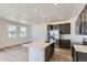 Bright, modern kitchen with stainless steel appliances, island, and dark cabinets, offering a clean aesthetic at 1978 S Haleyville Way, Aurora, CO 80018