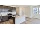 Modern kitchen boasts stainless steel appliances, a stylish island, and sleek dark cabinetry for a contemporary feel at 1978 S Haleyville Way, Aurora, CO 80018