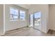 Bright and airy living room with hardwood floors, large windows, and a sliding glass door leading to a balcony at 1978 S Haleyville Way, Aurora, CO 80018