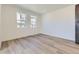 Bright living room featuring hardwood floors, white walls, and ample natural light streaming through large windows at 1978 S Haleyville Way, Aurora, CO 80018