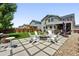 Beautiful backyard with a stone firepit, outdoor seating, and lush lawn at 16975 Melody Dr, Broomfield, CO 80023