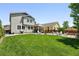 Expansive backyard featuring a lush lawn, covered patio, and outdoor grill area at 16975 Melody Dr, Broomfield, CO 80023