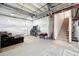 Unfinished basement with a comfortable seating area and staircase leading upstairs at 16975 Melody Dr, Broomfield, CO 80023