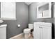 Cozy half bath with tiled floor, vanity sink, and natural light from window creates a functional space at 16975 Melody Dr, Broomfield, CO 80023