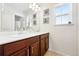 Well lit bathroom with double sinks, cherry cabinets, and anchor themed decor at 16975 Melody Dr, Broomfield, CO 80023