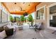 Spacious covered patio featuring comfortable seating, a ceiling fan, and views of the landscaped backyard at 16975 Melody Dr, Broomfield, CO 80023