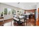 Bright dining area with large windows, hardwood floors, and a stylish dining table at 16975 Melody Dr, Broomfield, CO 80023