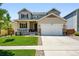 Attractive two-story home featuring a manicured lawn and a two-car garage with stone accents at 16975 Melody Dr, Broomfield, CO 80023