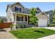 Charming two-story home with a well-manicured lawn, inviting front porch, and attached two-car garage at 16975 Melody Dr, Broomfield, CO 80023