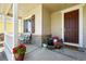 Welcoming front porch with stone accents, potted plants, and a charming seating area by the front door at 16975 Melody Dr, Broomfield, CO 80023