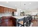 Gourmet kitchen boasts a large island, stainless steel appliances, and gorgeous pendant lighting for an inviting space at 16975 Melody Dr, Broomfield, CO 80023