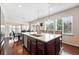 Bright, open kitchen with large center island, stainless steel dishwasher, and adjacent dining area filled with natural light at 16975 Melody Dr, Broomfield, CO 80023