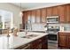 Well-equipped kitchen featuring stainless steel appliances, stylish backsplash, and a large island with seating and storage at 16975 Melody Dr, Broomfield, CO 80023