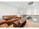 Upstairs loft area showcasing a comfortable leather sofa and a rustic wooden coffee table, perfect for relaxation at 16975 Melody Dr, Broomfield, CO 80023