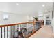Open loft space with a wrought iron railing overlooking lower level, a versatile and bright area for relaxation at 16975 Melody Dr, Broomfield, CO 80023