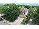 Aerial view of a charming two-story home with mature trees and a well-manicured lawn at 4164 E 135Th Pl, Thornton, CO 80241