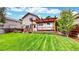 Enjoy the outdoors on the wooden deck overlooking the lush, green backyard of this lovely home at 4164 E 135Th Pl, Thornton, CO 80241