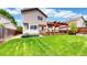 This home boasts a well-maintained lawn and a wooden deck perfect for outdoor entertaining in the backyard at 4164 E 135Th Pl, Thornton, CO 80241