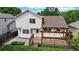 Charming backyard featuring a wooden deck with pergola, a garden bed, and a spacious lawn area at 4164 E 135Th Pl, Thornton, CO 80241