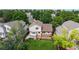 Aerial view of the backyard with a deck, pergola, garden, and lush green lawn, surrounded by mature trees at 4164 E 135Th Pl, Thornton, CO 80241