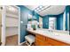 Bathroom featuring a single sink vanity with wood cabinets and a walk-in closet at 4164 E 135Th Pl, Thornton, CO 80241
