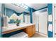 Bathroom featuring a single sink vanity with wood cabinets, vanity seating, and frosted glass shower at 4164 E 135Th Pl, Thornton, CO 80241