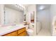Well-lit bathroom with a single sink vanity, ample counter space, and convenient laundry area at 4164 E 135Th Pl, Thornton, CO 80241